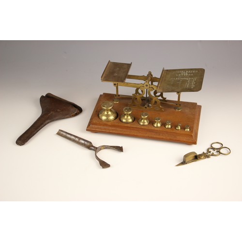 250 - A set of brass postal scales, early 20th century, upon a mahogany plinth base with seven graduated w... 