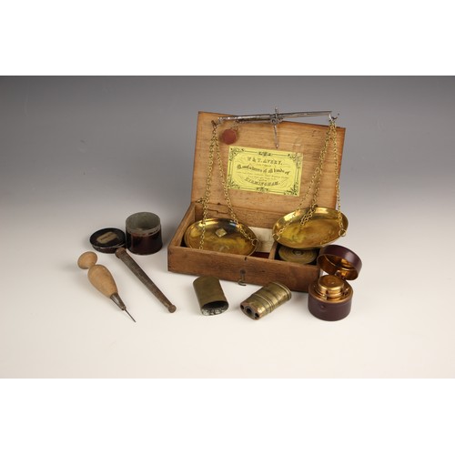 250 - A set of brass postal scales, early 20th century, upon a mahogany plinth base with seven graduated w... 