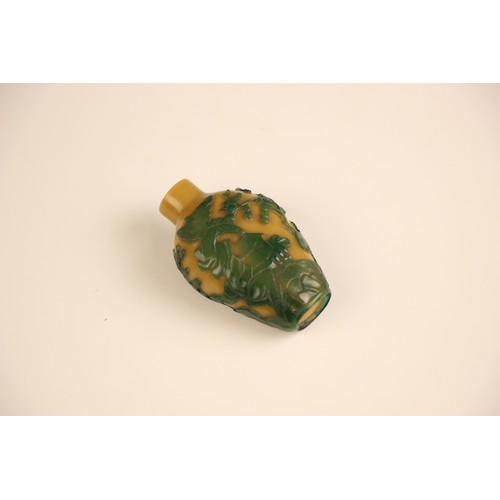 336 - A Chinese Peking glass green overlay, yellow snuff bottle, 19th century, of high shouldered form, de... 