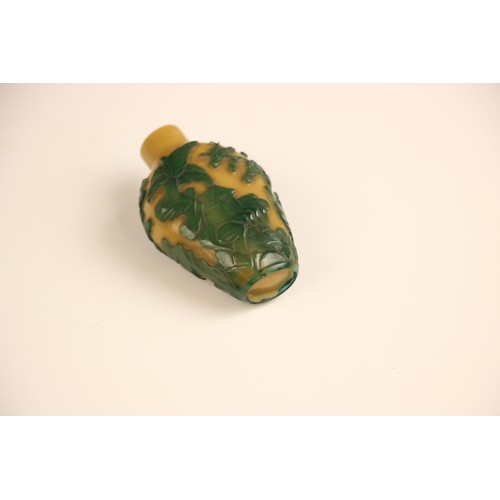 336 - A Chinese Peking glass green overlay, yellow snuff bottle, 19th century, of high shouldered form, de... 