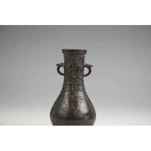 321 - A Chinese Archaic style bronze vase, in arrow type form, the swollen body leading to a tapered neck ... 