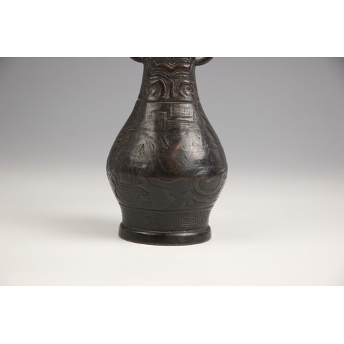 321 - A Chinese Archaic style bronze vase, in arrow type form, the swollen body leading to a tapered neck ... 