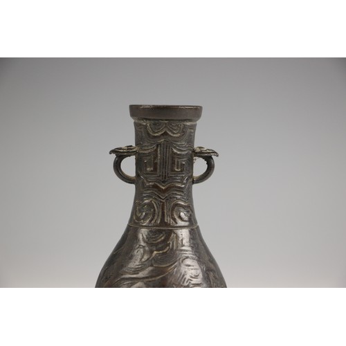 321 - A Chinese Archaic style bronze vase, in arrow type form, the swollen body leading to a tapered neck ... 