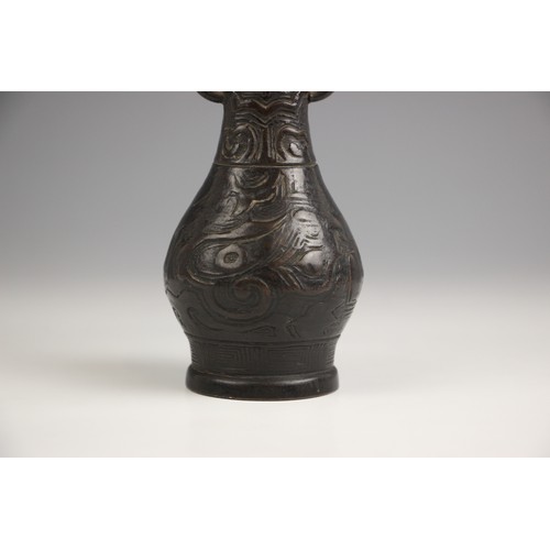 321 - A Chinese Archaic style bronze vase, in arrow type form, the swollen body leading to a tapered neck ... 