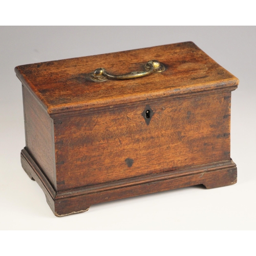 1070 - A George III mahogany tea caddy, the top with a brass swing handle opening to later interior fitted ... 