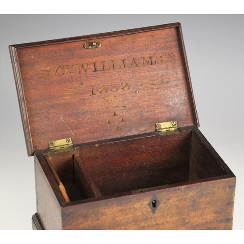 1070 - A George III mahogany tea caddy, the top with a brass swing handle opening to later interior fitted ... 