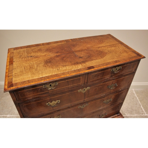 1097 - A George II walnut chest on stand, mid 18th century, the quarter veneered and crossbanded top over a... 