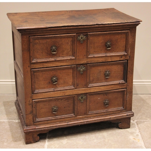 1101 - A Jacobean oak chest of drawers, the plank top above an arrangement of three elm lined long drawers,... 