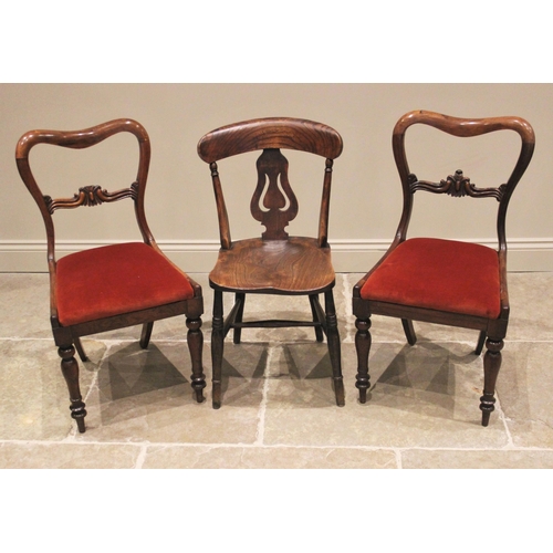 1168 - A pair of early Victorian rosewood dining chairs, each with a compressed balloon back, carved crest ... 