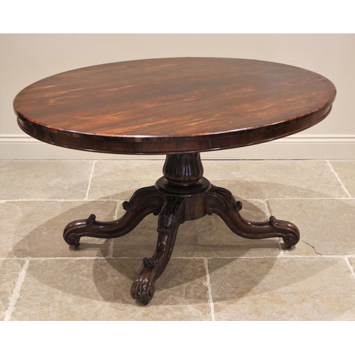 1173 - A Victorian rosewood loo table, the tilting oval top upon a tapering acanthus pedestal and circular ... 