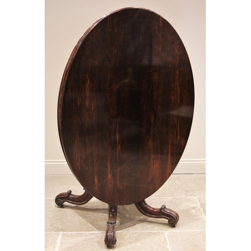 1173 - A Victorian rosewood loo table, the tilting oval top upon a tapering acanthus pedestal and circular ... 