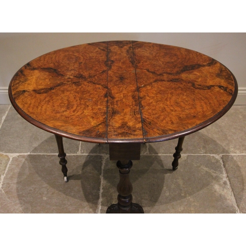 1181 - A Victorian figured walnut Sutherland table, the moulded oval drop leaf top upon baluster and bulbou... 