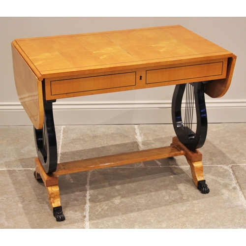 1199 - A Biedermeier style satin birch sofa table, 20th century, the rectangular top with rounded leaves up... 