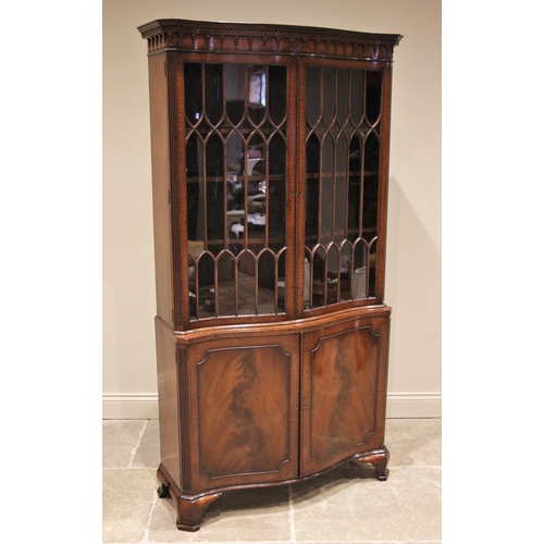 1200 - A Chippendale style serpentine mahogany display cabinet, mid 20th century, the moulded Greek key pat... 