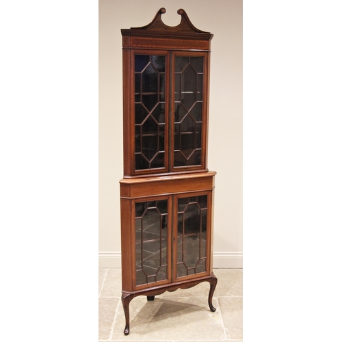 1203 - An Edwardian mahogany freestanding corner display cabinet, with a swan neck pediment over a satinwoo... 