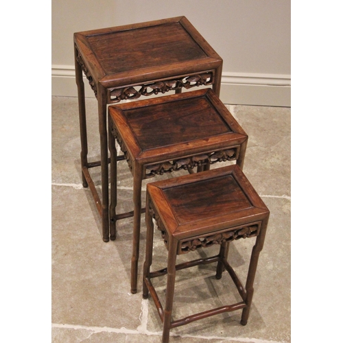 1210 - A nest of three Chinese rosewood tables, 20th century, of rectangular form, with a carved vinery ope... 