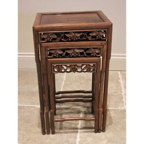 1210 - A nest of three Chinese rosewood tables, 20th century, of rectangular form, with a carved vinery ope... 