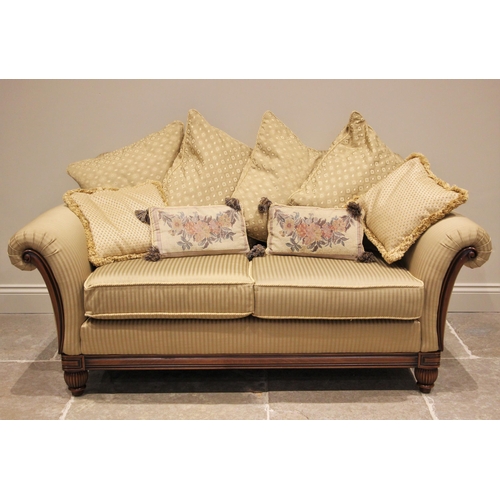 1219 - A pair of Empire style sofas by Wade, late 20th century, in striped ochre fabric, the padded scroll ... 