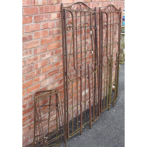 1226 - A pair of wrought iron folding garden arbours, with open scroll work side panels, each measures 185c... 