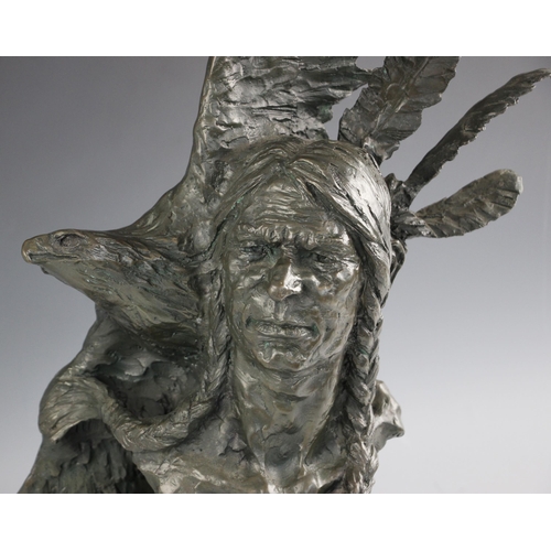 514 - American school (20th century), a bronze patinated spelter figure of a Native American shamen with e... 