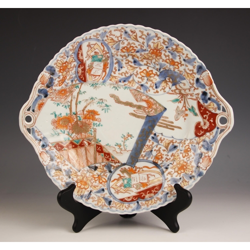 740 - A Japanese Imari porcelain two-handled dish,  Meiji period (1868-1912), the circular shallow bowl de... 