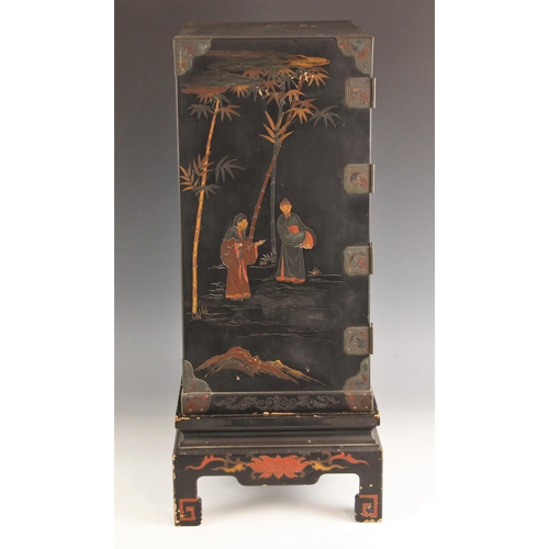 750 - A Japanese black lacquer kodansu, Meiji period, 1868-1912, applied in relief with pagoda landscapes,... 