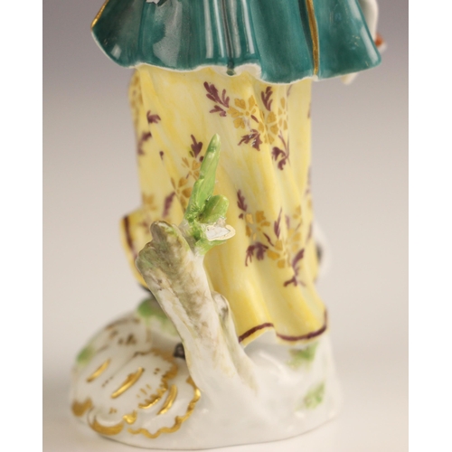 765 - A Meissen porcelain figure of a huntswoman, late 19th century, the figure modelled standing holding ... 