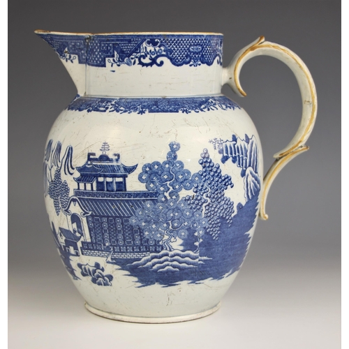 776 - A pearlware blue and white jug of large proportions, early 19th century, of ovoid form with raised n... 