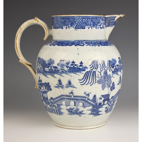 776 - A pearlware blue and white jug of large proportions, early 19th century, of ovoid form with raised n... 