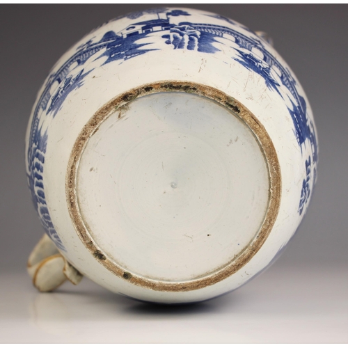 776 - A pearlware blue and white jug of large proportions, early 19th century, of ovoid form with raised n... 