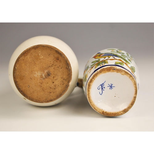 777 - Two tin glazed earthenware lidded ewers or cruets, 18th/19th century, one decorated in blue and whit... 