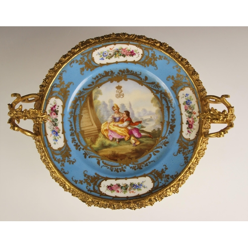 788 - A Sevres Chateau des Tuileries ormolu mounted tazza, 19th century, the well painted with a courting ... 