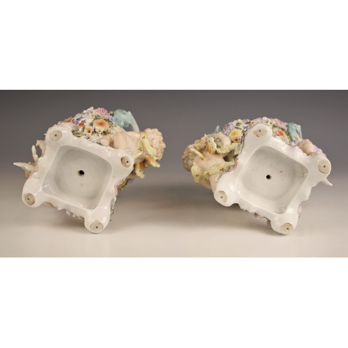 790 - A pair of German porcelain pot pourri and covers, 19th century, each modelled with cherubs supportin... 