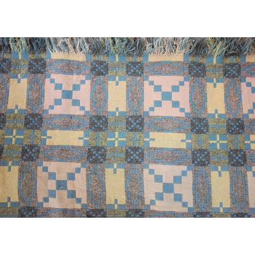 1034 - A Welsh wool blanket, of traditional reversible geometric design in blue, lime, pink, cream and grey... 