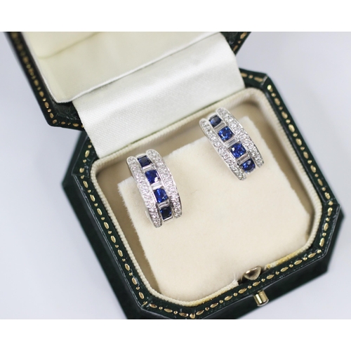 375 - A pair of untested sapphire and diamond half hoop/cuff style earrings, the central channel with four... 