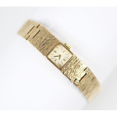 463 - A 9ct yellow gold ladies wristwatch, the square cream coloured dial with baton markers, set to a tex... 