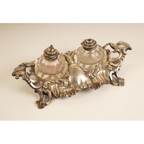 83 - A Victorian silver inkwell, John Harrison and Co, Sheffield 1860, modelled in Rococo style with acan... 