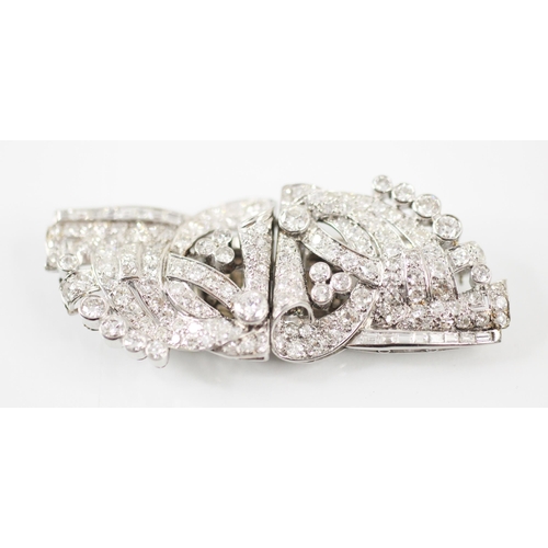 199 - A mid 20th century diamond duet clips/brooch, the mixed cut diamonds within a white metal openwork s... 