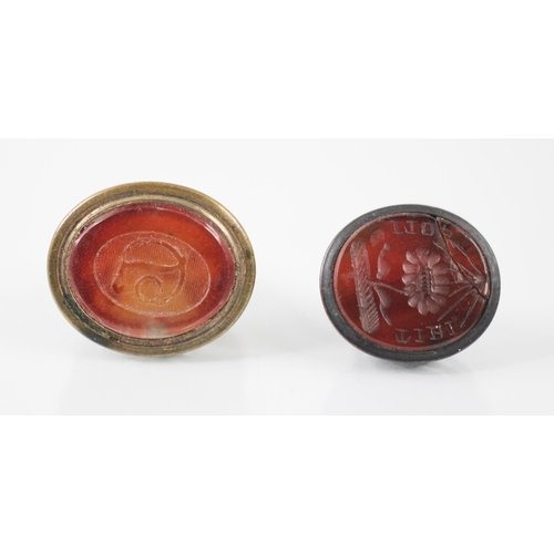 214 - A 19th century carnelian set seal, the oval shaped carnelian intaglio with sinuous 'D' initial to ce... 