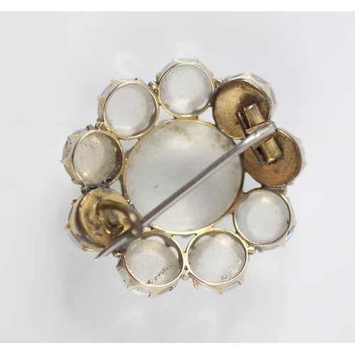 242 - An untested moonstone brooch, the ten round cabochon moonstones within a flowerhead design, open to ... 