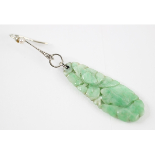 254 - A pair of Art Deco jade, diamond and seed pearl drop earrings, the tapering oval panel of jade carve... 