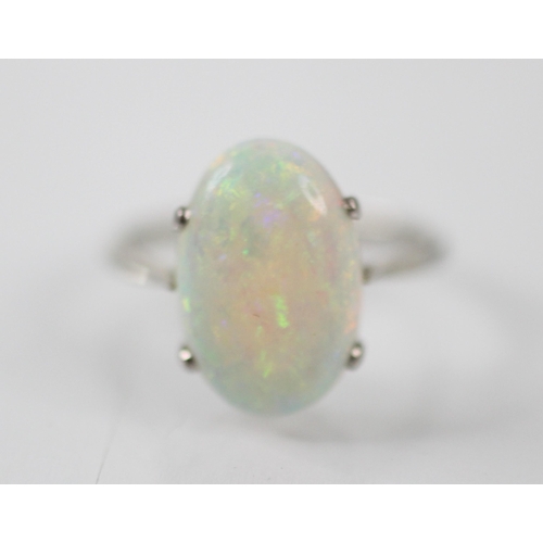 274 - An opal necklace and ring, the opal set necklace within a diamond set white metal surround, upon a f... 