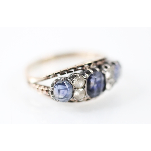 285 - An untested sapphire and paste ring, the three mixed cut sapphires interspersed with paste, set with... 