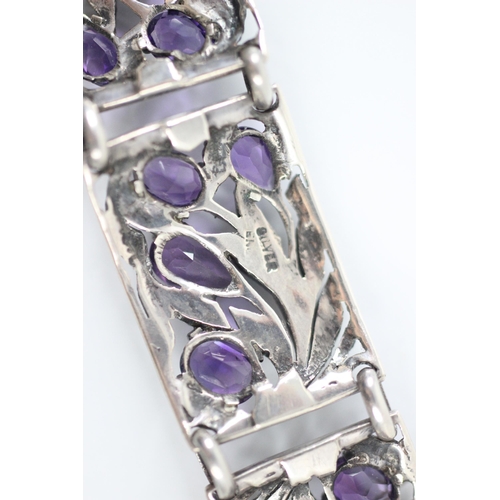 286 - An Arts and Crafts style untested amethyst bracelet, the five openwork panels with foliate detail se... 