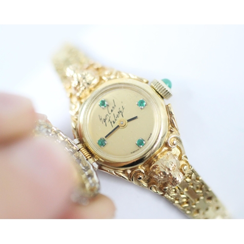 444 - A Faberge diamond cocktail watch, the circular gold coloured dial with four green stone detail, sign... 