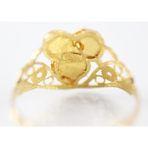 208 - A yellow metal ring, the openwork head with applied cannetille style decoration with swirl detail, l... 