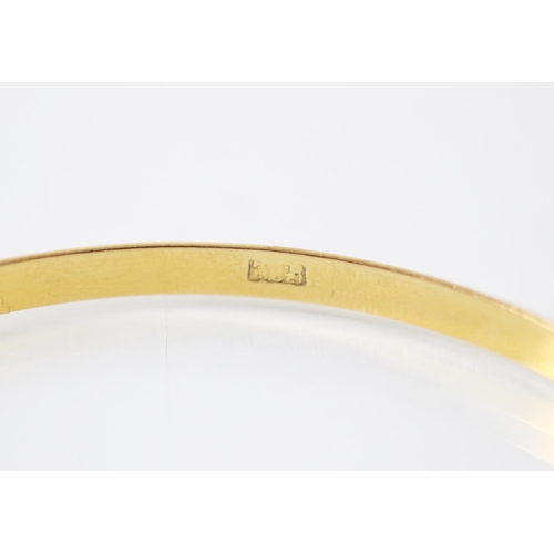 211 - A yellow metal bangle, the plain polished bangle with indistinct stamp to interior, inner diameter 6... 