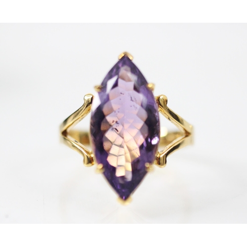 298 - An untested amethyst dress ring, the marquise cut amethyst six claw set in yellow metal, leading to ... 