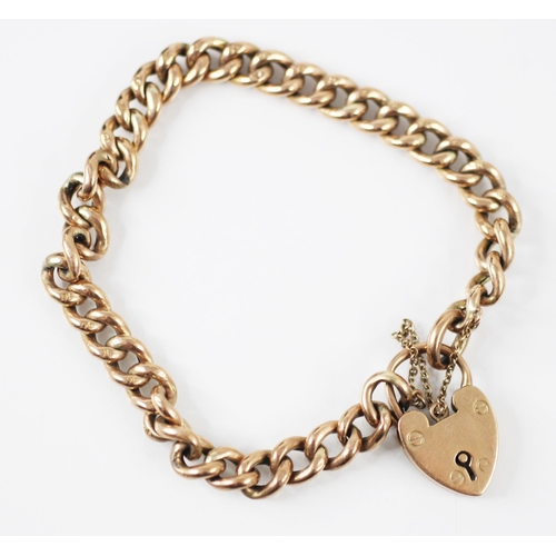 299 - A yellow metal hollow link bracelet, the curb links each stamped '9C' with padlock heart clasp stamp... 