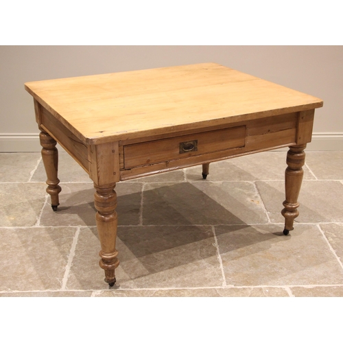 1166 - A Victorian pine kitchen table, the rectangular slab top with rounded corners above a single frieze ... 